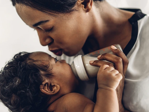 Mom kisses baby