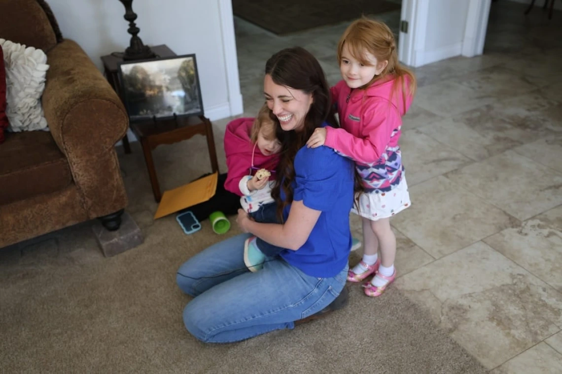 Carolyn Larsen and her kids, in a photo by Jack Orleans of Cronkite News