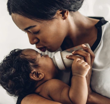 Mom kisses baby